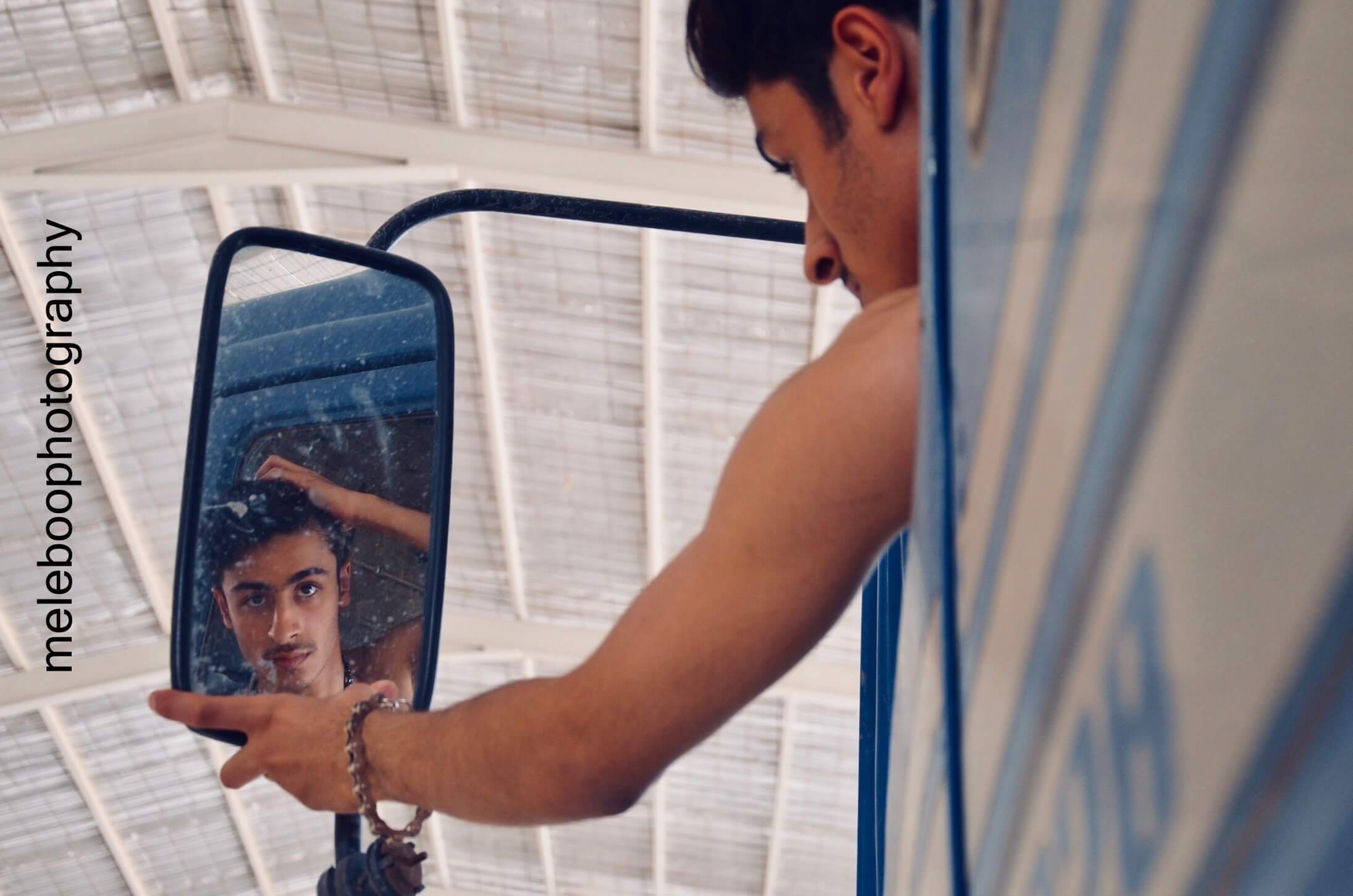 hassan looking in the sideview mirror